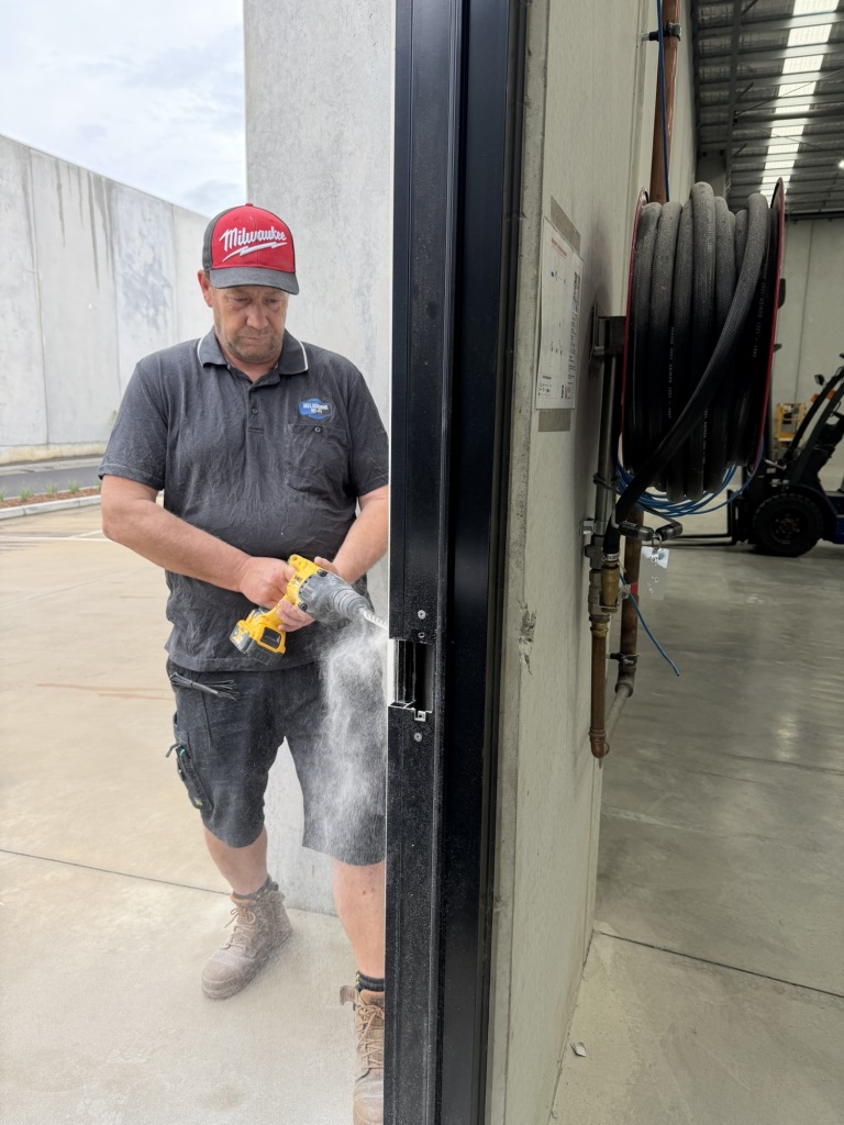 Melbourne WiFi technician installing access control on warehouse door